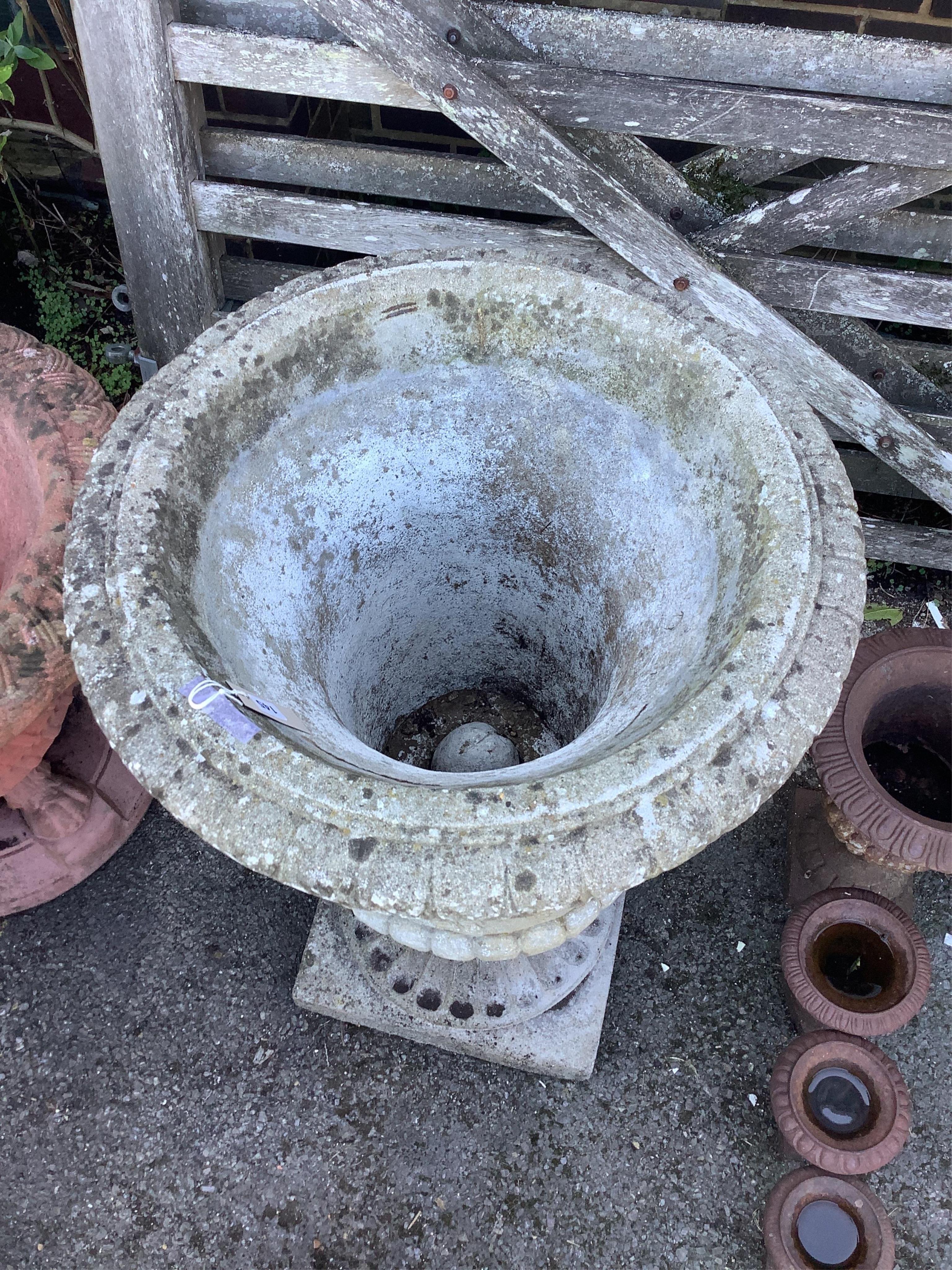 A reconstituted stone campana garden urn, diameter 61cm, height 93cm. Condition - fair